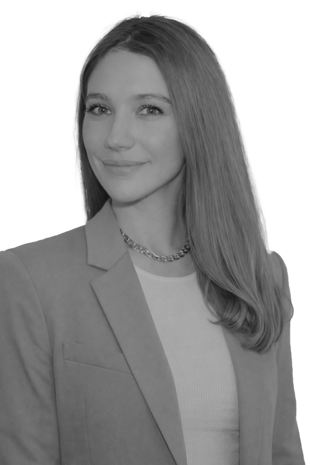 Libby Gilbert, A civil litigation lawyer in Markham, Ontario with long straight hair wearing a blazer, a light-colored top, and a chain necklace, smiling softly at the camera against a plain white background.